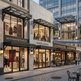 Commercial building with Montmartre Fashion, Lumiere Salon, and Cafe Allat storefronts.