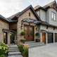 Stately house with stone facade, wooden doors, and decorative elements.