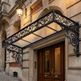Decorative metal canopy over a door of an elegant building