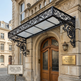 Decorative canopy over a grand entrance with 'Heritage Restoration Project' sign on a historic building.