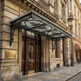 Decorative canopy over a historic entrance of a building with ornate details.