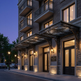 Elegant building entrance with decorative canopy at dusk