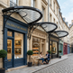 Decorative glass awning with heritage scrollwork and semi‑circular design.