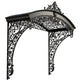 Curved wrought iron awning with dense floral scrollwork above exterior entrance.