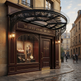 Semi‑circular outdoor glass awning with ornate wrought iron scrollwork.