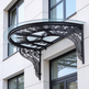 Curved glass entrance canopy featuring decorative wrought iron brackets.