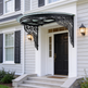Curved glass entrance canopy featuring decorative wrought iron brackets.