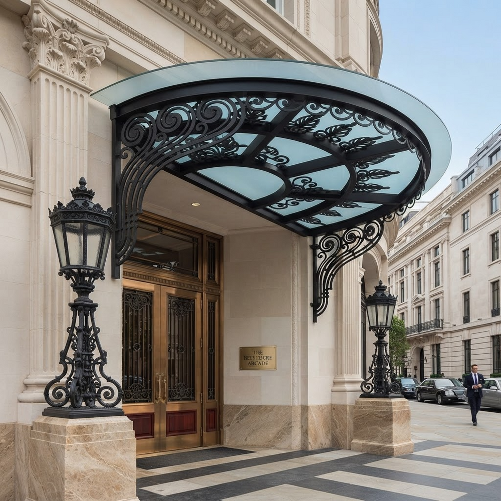 Outdoor entrance awning featuring curved glass and ornate ironwork.