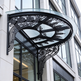 Exterior glass and iron canopy with scrollwork design