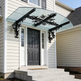 Wrought iron scrollwork awning with triple‑beam reinforcement and lantern lighting.