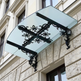 Wrought iron scrollwork awning with triple‑beam reinforcement and lantern lighting.
