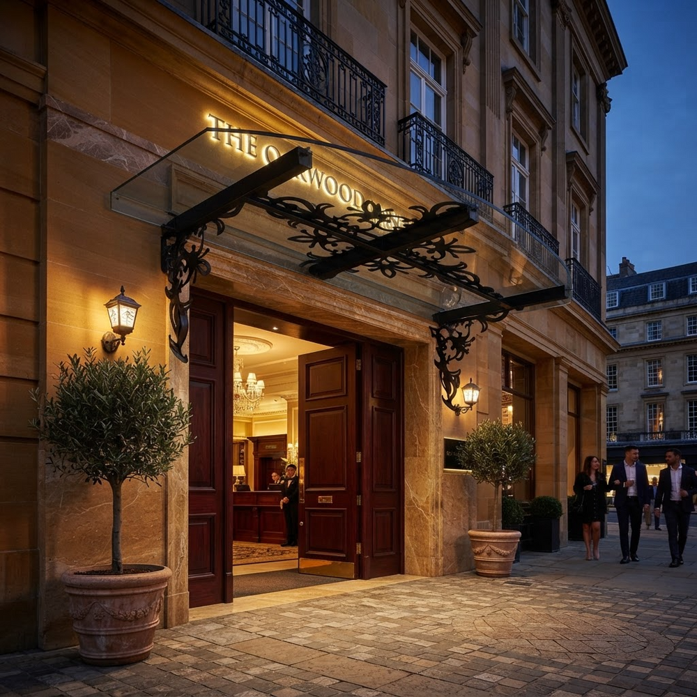 Lantern‑lit wrought iron canopy with curved transparent roof panel.