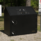 Black outdoor trash bin with USB charging ports on a gravel surface with trees in the background.