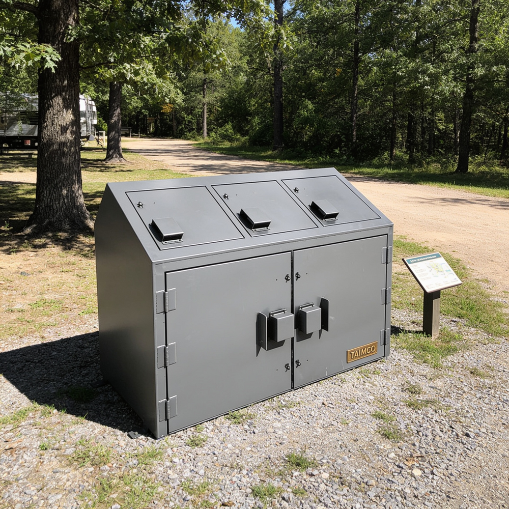 Gray outdoor trash bin with three compartments in a park setting