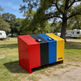Durable steel waste container with two lift‑up lids and smooth red powder coat