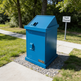 Modern black steel trash bin with rectangular top slot and TAIMCO logo plate