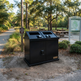 Heavy‑duty steel waste bin featuring two angled deposit openings and dual doors