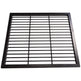 Black steel round‑bar window well grate installed beside a stone exterior wall with surrounding landscaping.