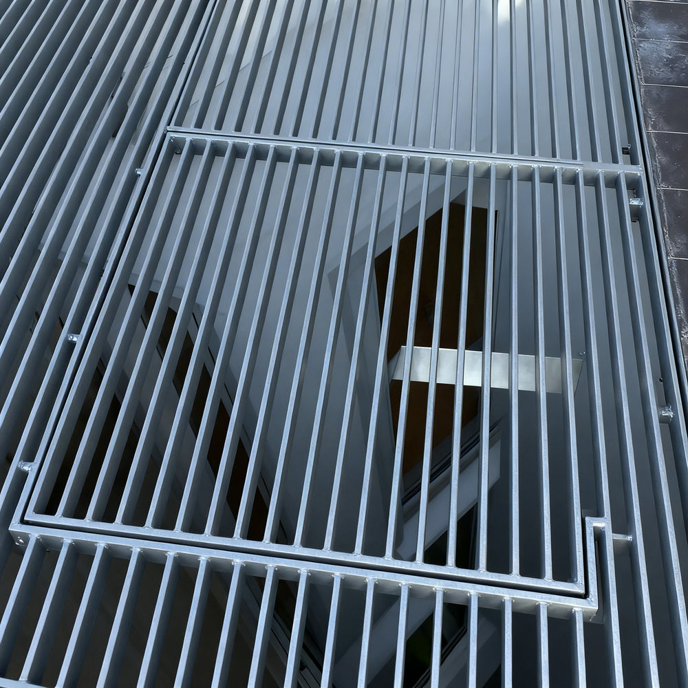 Metal gratings on a floor with a dark background